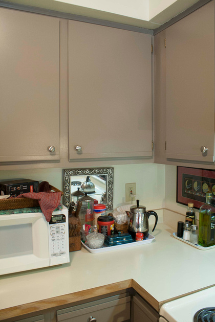 painted laminate cabinets with brushed nickel knobs via foobella.blogspot.com